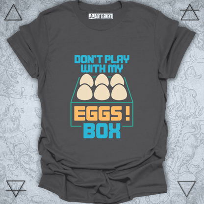 Gray t-shirt with 'Don't play with my eggs box' graphic design on a textured background
FUNNY GAMERS T-SHIRT