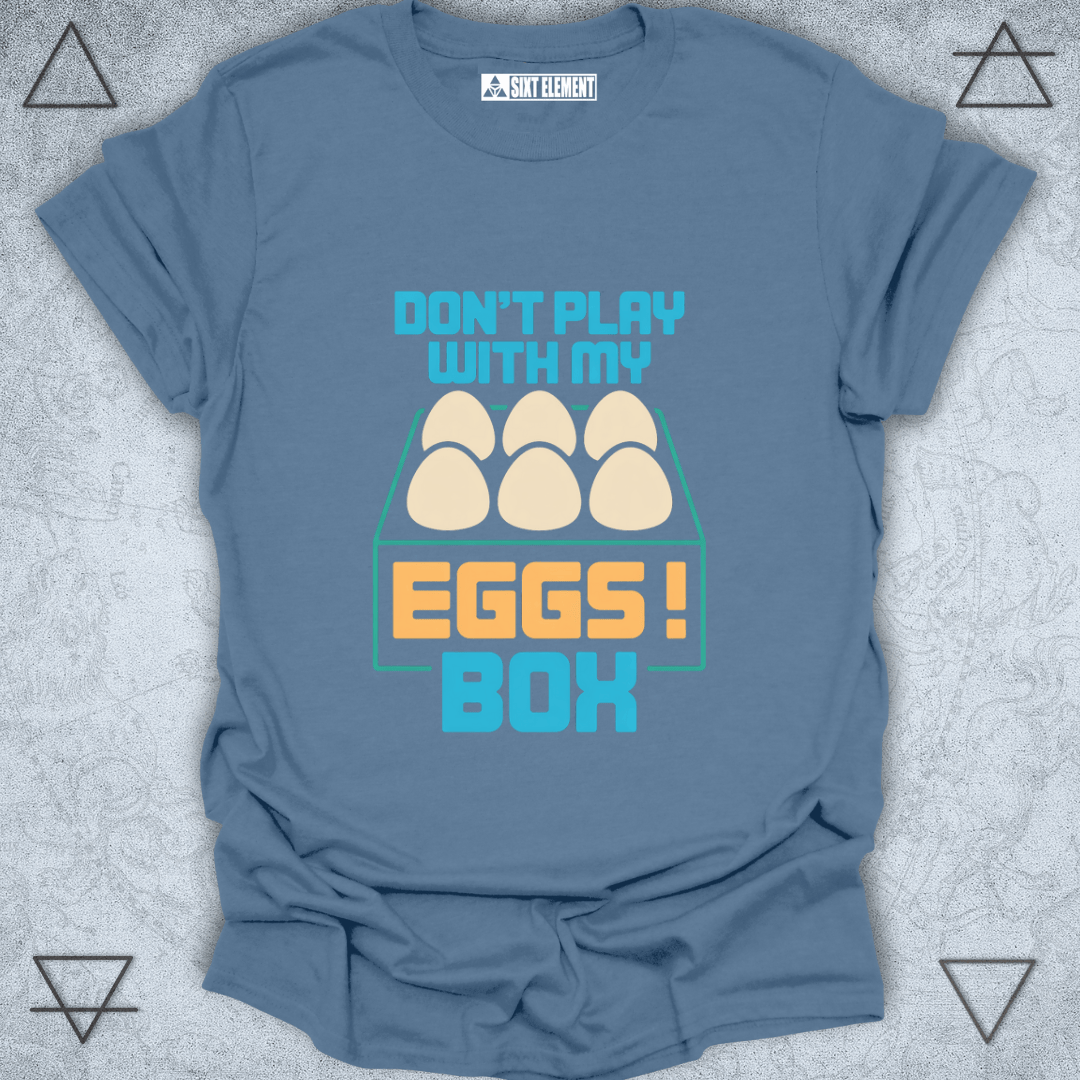 Blue t-shirt with 'Don't play with my eggs box' graphic on a textured gray background
FUNNY GAMERS T-SHIRT