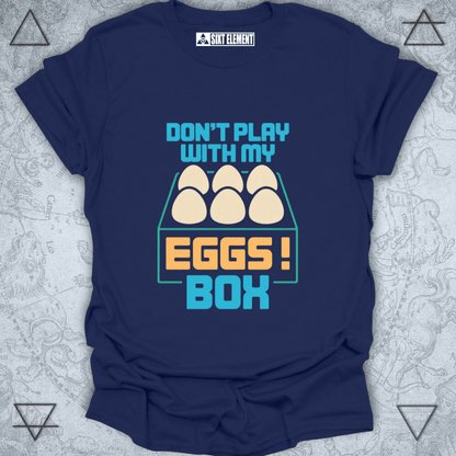 Navy blue t-shirt with 'Don't play with my eggs box' graphic on a textured gray background
FUNNY GAMERS T-SHIRT