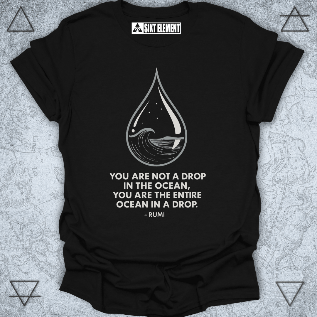 Minimalist black T-shirt design featuring a water droplet illustration containing an ocean wave, stars, and a moon. Below the artwork is the Rumi quote: “You are not a drop in the ocean, you are the entire ocean in a drop.” The design symbolizes unity, consciousness, and spiritual awareness.